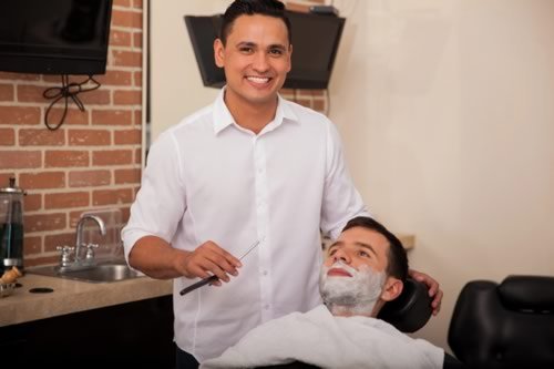 A Barber Shaving a Customer